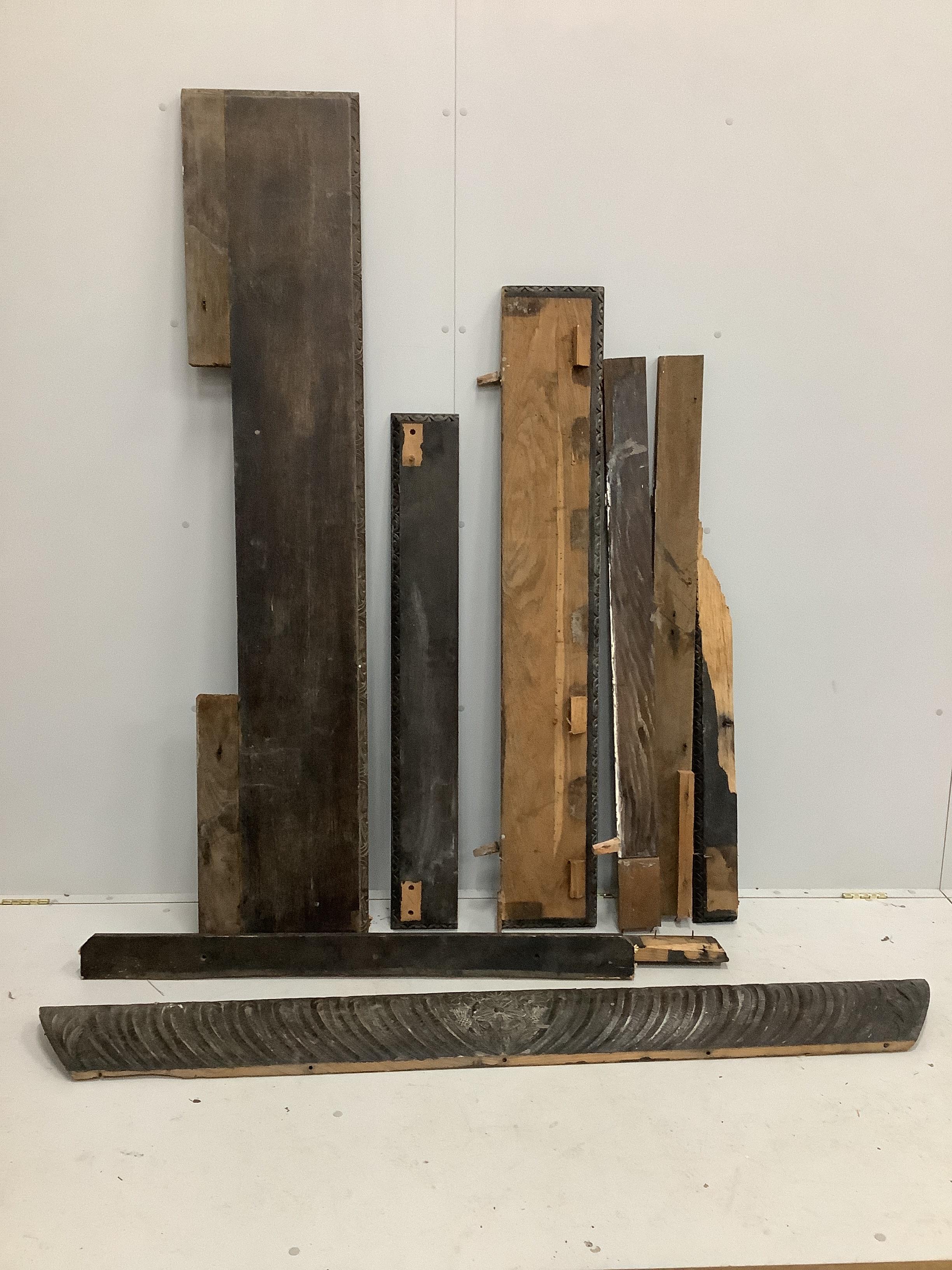 A late 19th century Flemish carved oak fire surround, disassembled, width 182cm